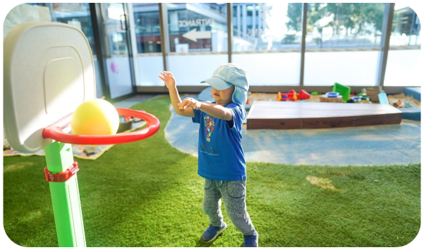 Child practicing basketball skills as part of a community sports program.